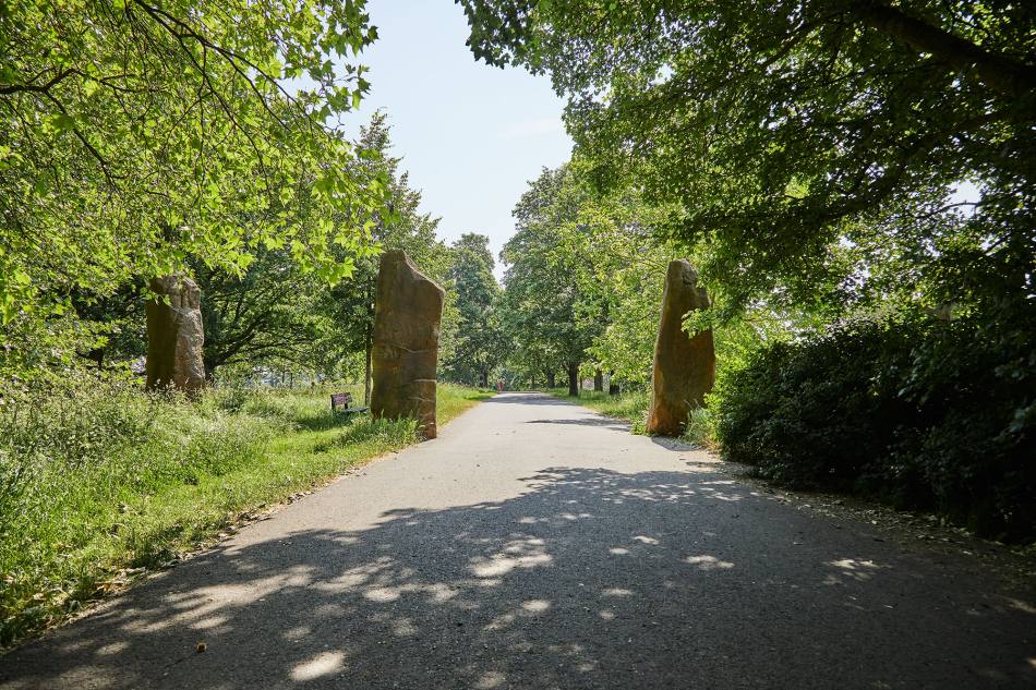 3 large sandstone blocks that cross the path. There are trees at the edge of the path.